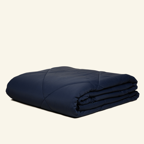 The Lightweight UltraCool Comforter folded in the navy color