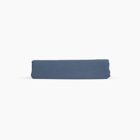 Avec linen fitted sheet in harbor folded neatly on a white background