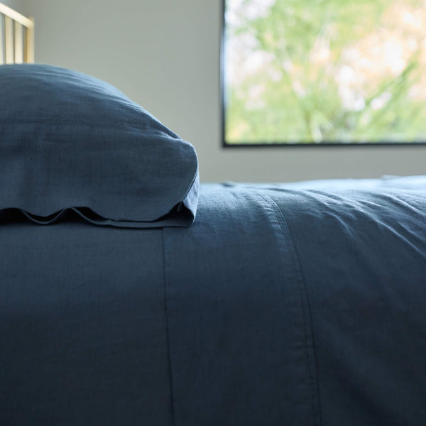 A detailed side view of a well-made bed made with Avec bedding