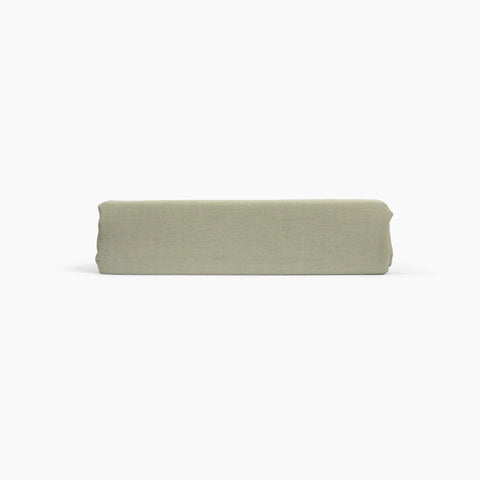 Avec linen fitted sheet in sage folded neatly on a white background