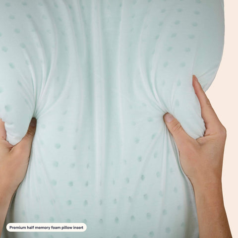 A woman squeezing the memory foam insert of the Slumber Cloud Adjustable UltraCool Pillow